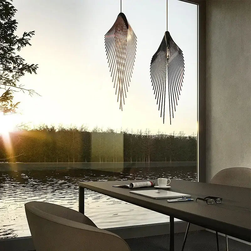 Two sleek black metal pendant lights with flying wing shape fins hang over a modern living room table