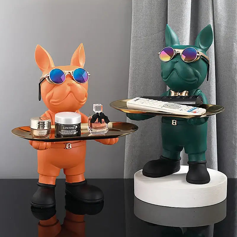 Two stylized decorbites french bulldog sculptures in orange and teal holding trays for living room decor
