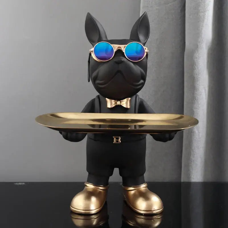 Modern black french bulldog sculpture by decorbites wearing blue sunglasses and gold accessories holding a key tray