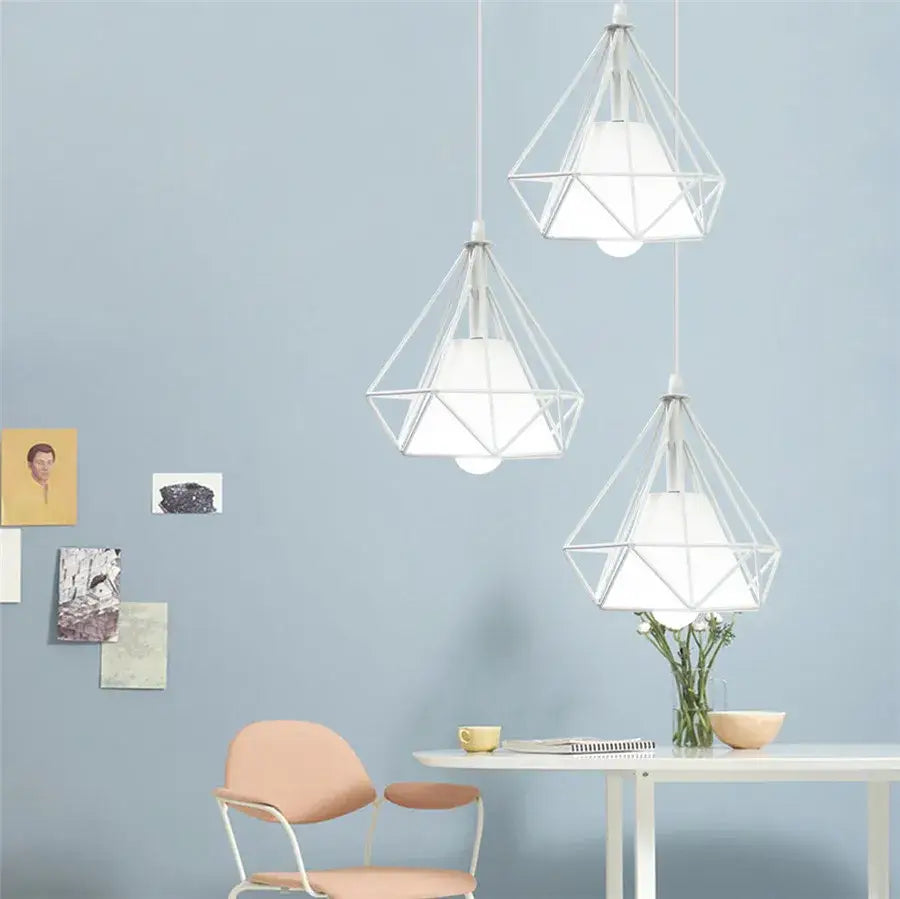 Three white geometric diamond pendant lights trio with wireframe design hanging for modern kitchen lighting