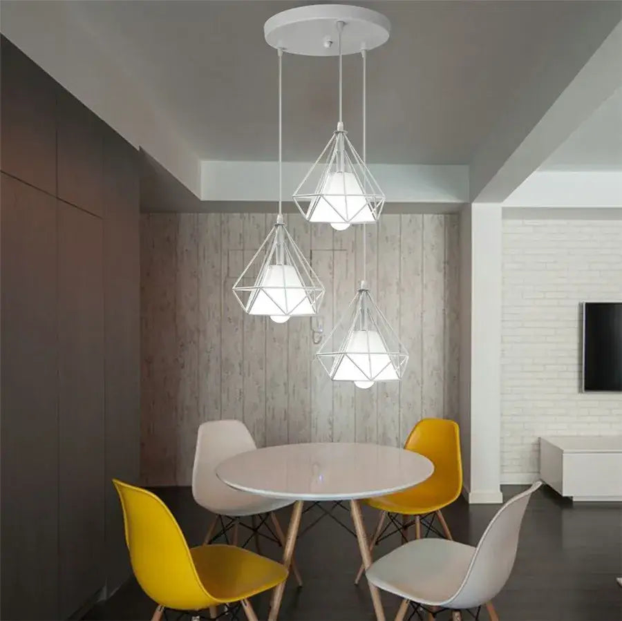 White geometric diamond pendant lights trio with wireframe design hanging above dining table for modern kitchen