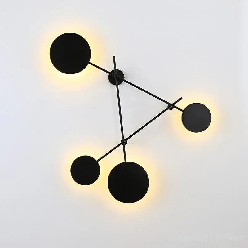 Modern black geometric iron wall lamp with four circular warm light fixtures for living room decorbites geometric iron wall