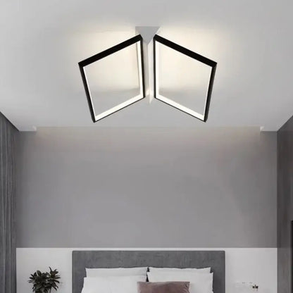 Modern black geometric led ceiling lights with two square panels emitting a warm glow for living room illumination