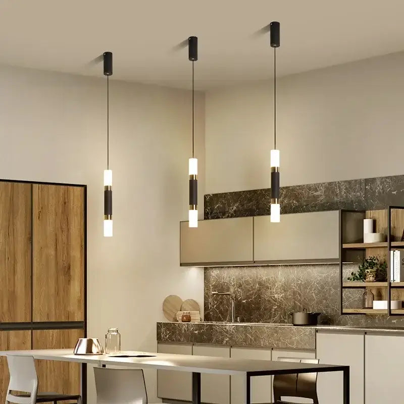 Three modern black geometric led pendant lights with cylindrical fixtures and frosted glass shades for living room decorbites
