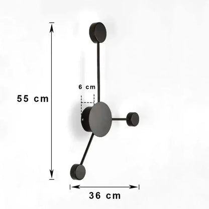 Black minimalist wall-mounted coat rack with four hooks complements modern black geometric led wall lamp design