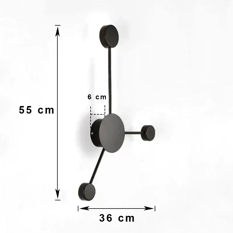 Black minimalist wall-mounted coat rack with four hooks complements modern black geometric led wall lamp design