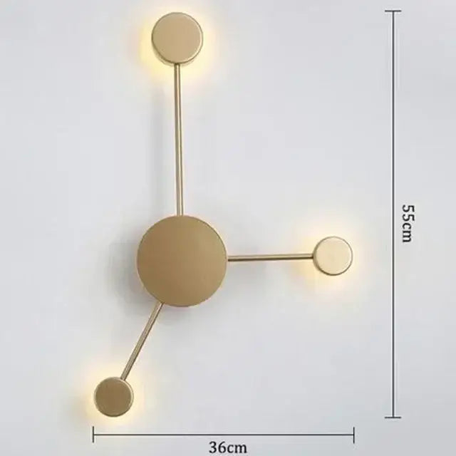 Gold-toned minimalist wall lamp with three circular led light fixtures in geometric pattern for bedroom use