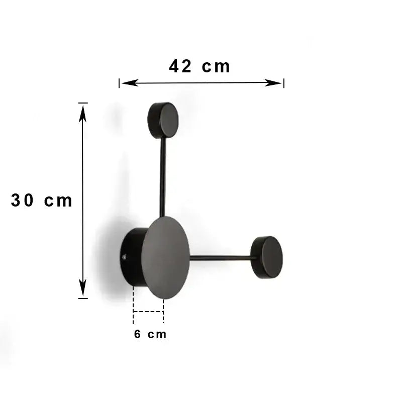 Modern black metal wall-mounted coat rack with circular and cylindrical elements paired with led wall lamp sconce