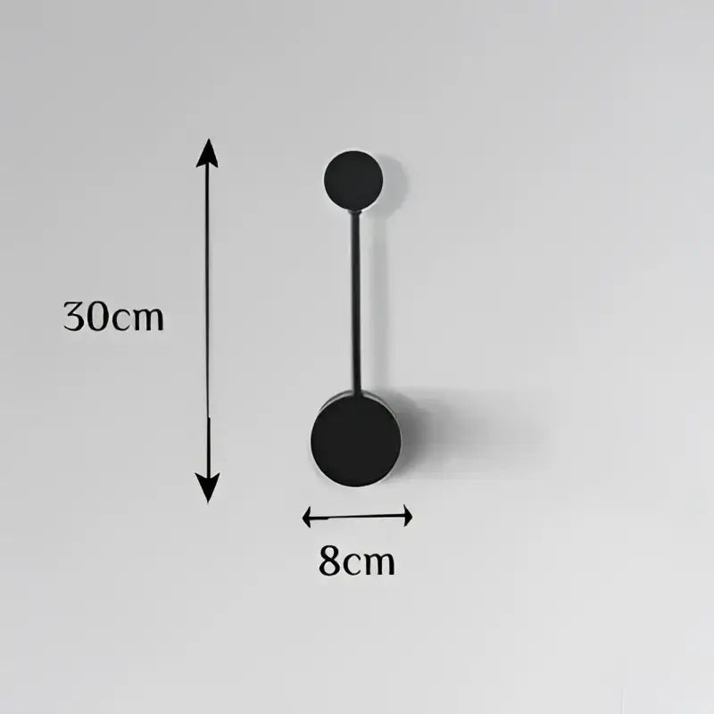 Modern black geometric led wall lamp featuring two circular discs and a slender rod for minimalist bedroom decor