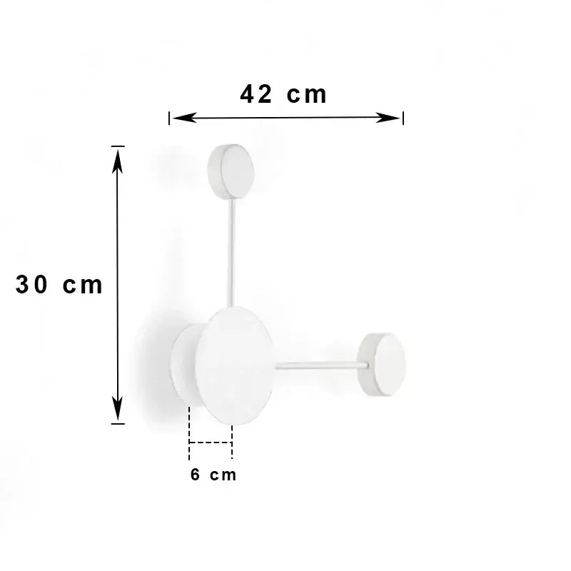 Minimalist white wall-mounted coat rack with three circular hooks paired with modern black geometric led wall lamp