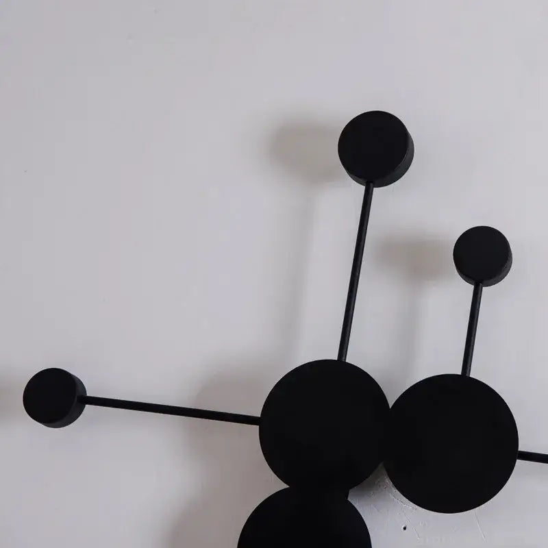 Modern black geometric led wall lamp with minimalist interconnected spheres and rods as stylish living room decorbites decor