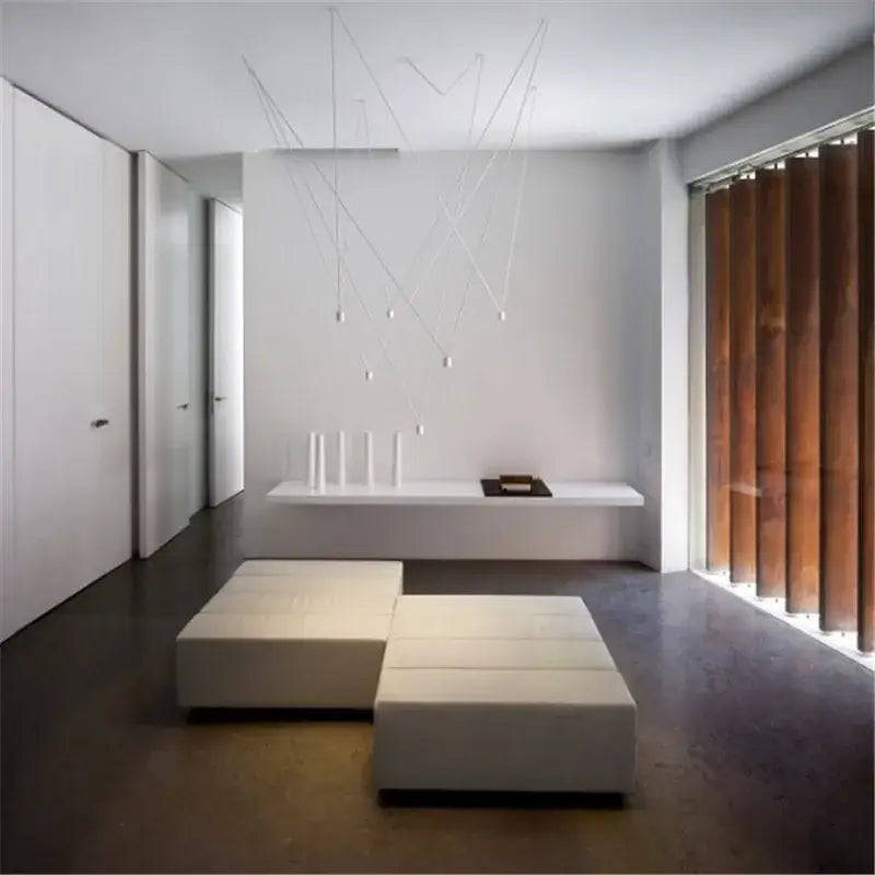 Minimalist white modular seating paired with modern black geometric led wire pendant light office chandelier decorbites geometric led