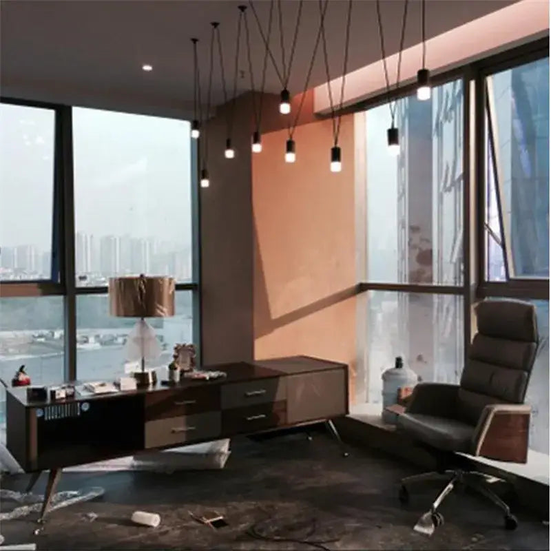 Black office chair with leather upholstery and wooden armrests below pendant light decorbites geometric led wire chandelier