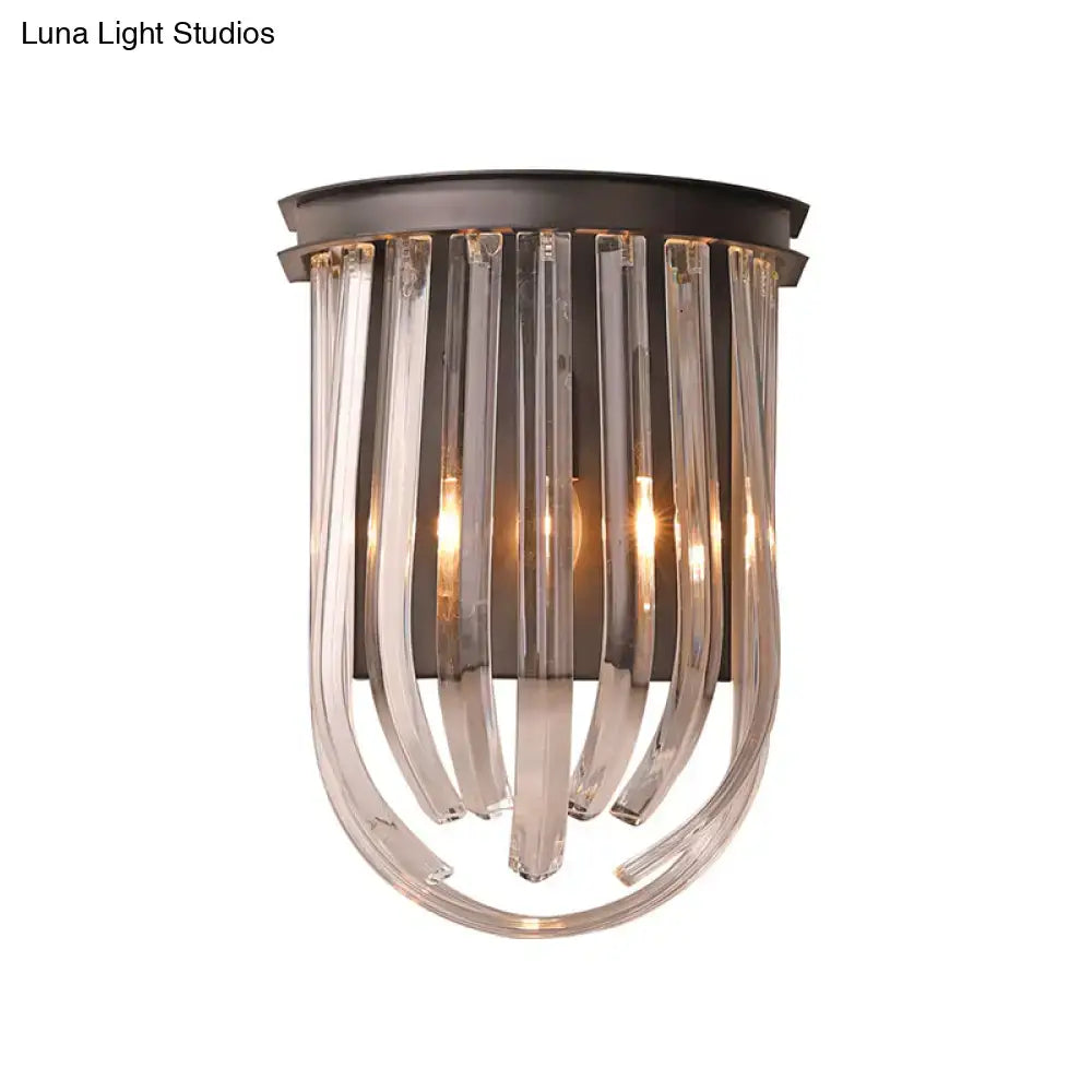 A modern semi oval wall light with black finish featuring dark bronze metal and clear curved glass rods for bedroom use