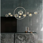 Modern black metal decorbites glass ball led chandelier with clear globe bulbs arranged circularly for dining room lighting
