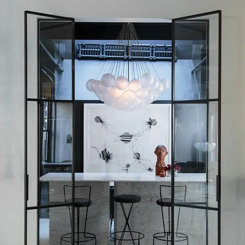 Modern black glass ball led chandelier with translucent white spherical bulbs suspended by thin metallic wires decorbites glass ball