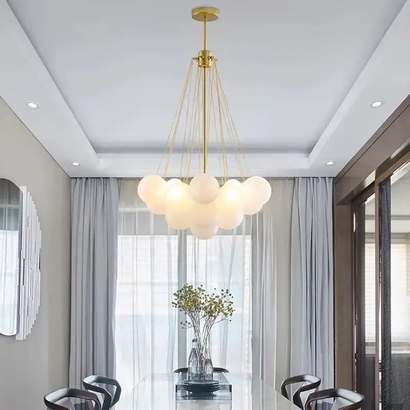 Gold-toned ball led chandelier with frosted glass globe shades suspended by thin cords for modern living room decorbites glass ball