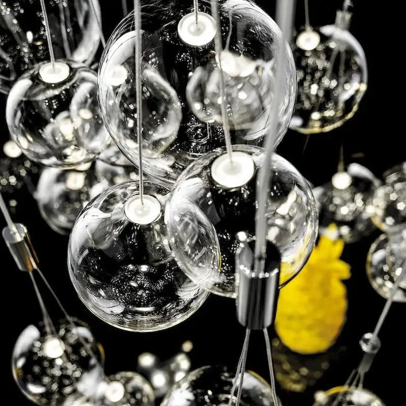 Modern black glass ball led pendant lamps featuring clear glass globe pendant lights with metallic fixtures for decorbites