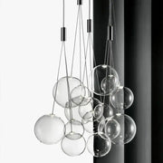 Modern black glass ball led pendant lamps featuring a clear glass sphere with sleek black metal hardware for kitchen decorbites pendant lamps