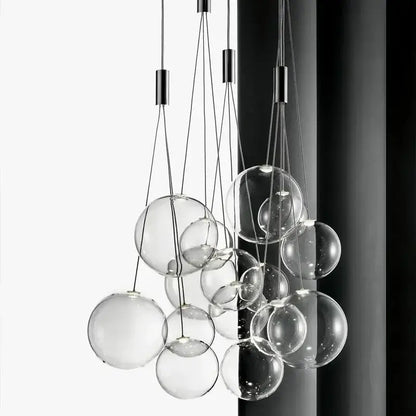 Modern black glass ball led pendant lamps with clear spherical bulbs suspended by thin metallic cords for kitchen decorbites glass ball design