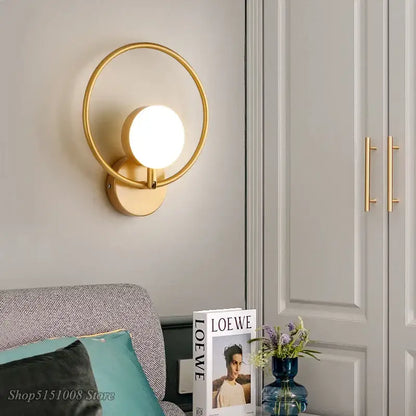 Modern black glass ball led wall lamp with gold-toned circular sconce and glowing glass ball led for stylish wall decorbites wall lamp