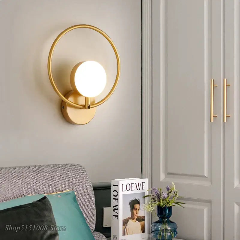 Modern black glass ball led wall lamp with gold-toned circular sconce and glowing glass ball led for stylish wall decorbites wall lamp
