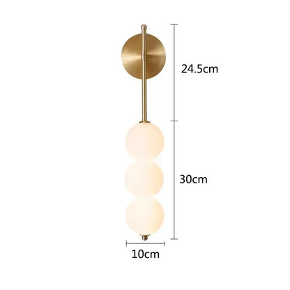 A modern black brass wall sconce with three frosted glass spheres for decorbites glass ball led living room decor