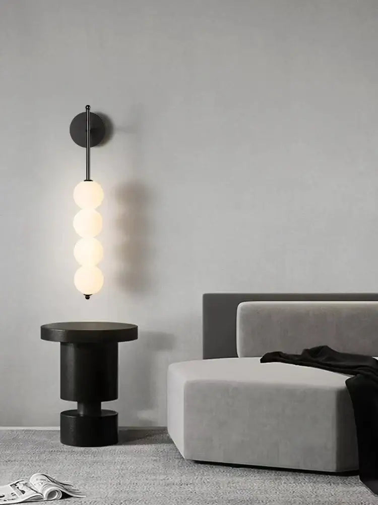 Modern black glass ball led wall sconce with four glowing spherical bulbs for living room decor by decorbites glass ball