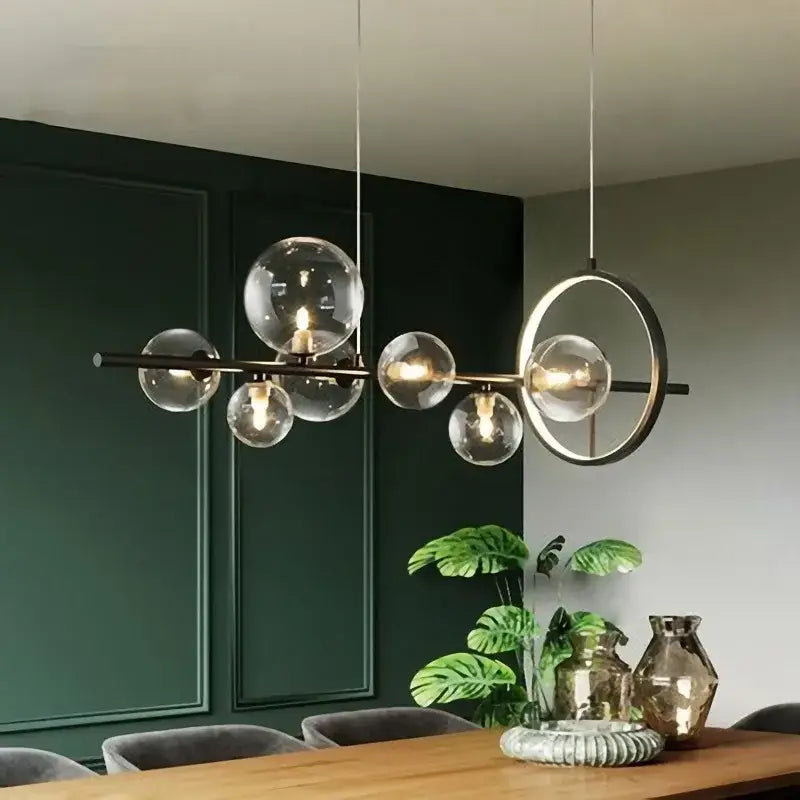 Modern black glass ball pendant lamps featuring brass and clear glass globe with circular accent for dining room decorbites glass ball pendant