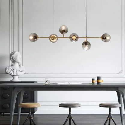 Modern brass pendant lamps with five black decorbites glass ball globes for dining room lighting and decor