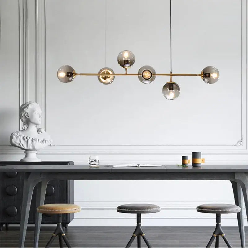 Modern brass pendant lamps with five black decorbites glass ball globes for dining room lighting and decor