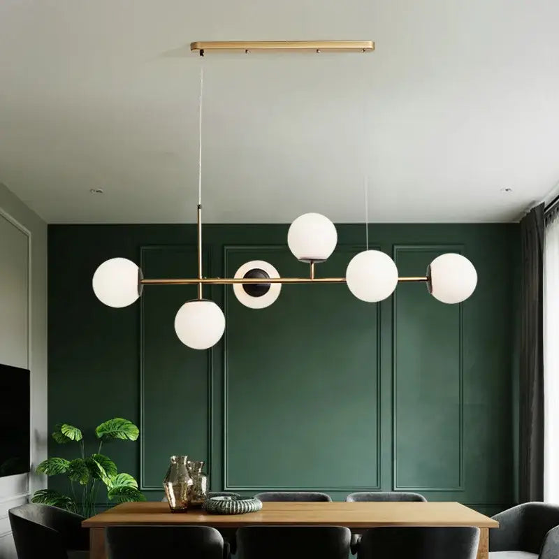 Modern black glass ball pendant lamps featuring a brass linear design with five frosted glass globe shades for dining room decorbites glass ball pendant