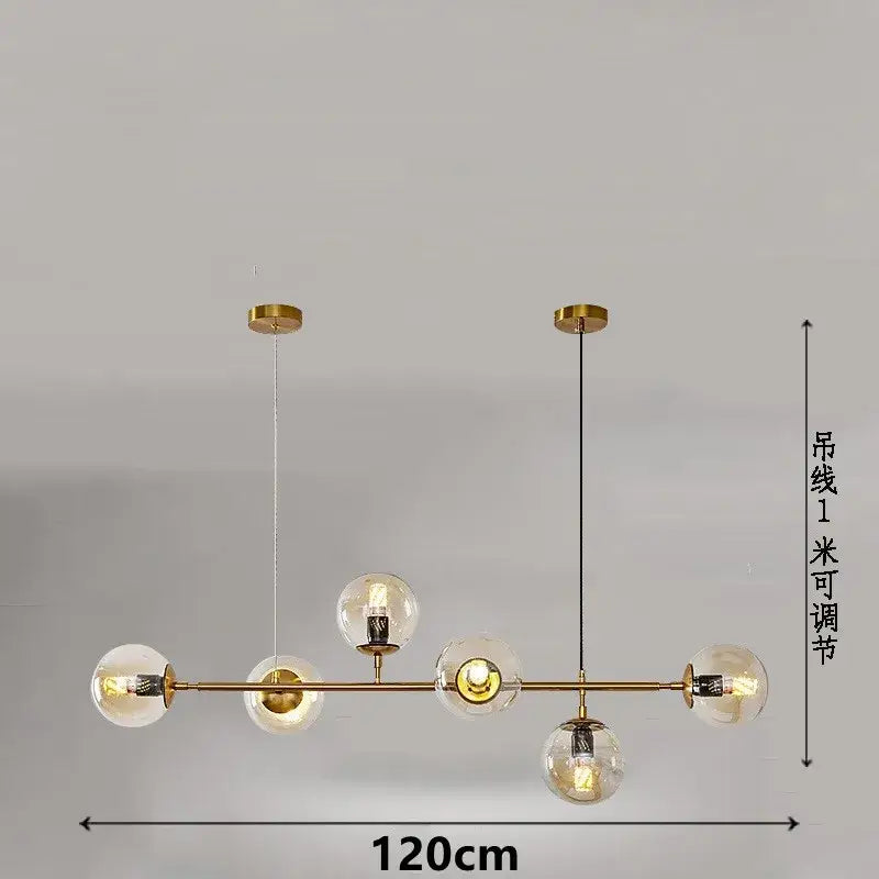Gold-toned modern pendant lamps with five clear glass ball pendants and adjustable hanging cords by decorbites