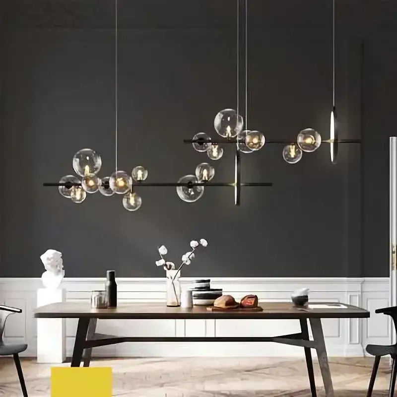 Modern black metal pendant lamps with clear glass ball pendant bulbs suspended by thin cords for dining room decorbites chandelier