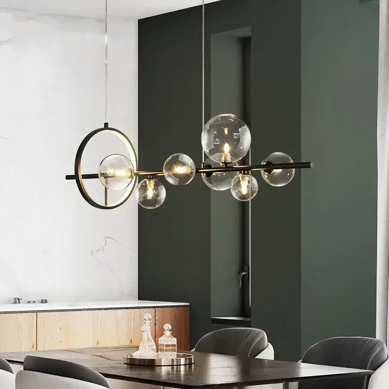 Modern black metal pendant lamps with clear glass ball globes and circular accents for dining room decorbites glass ball chandelier