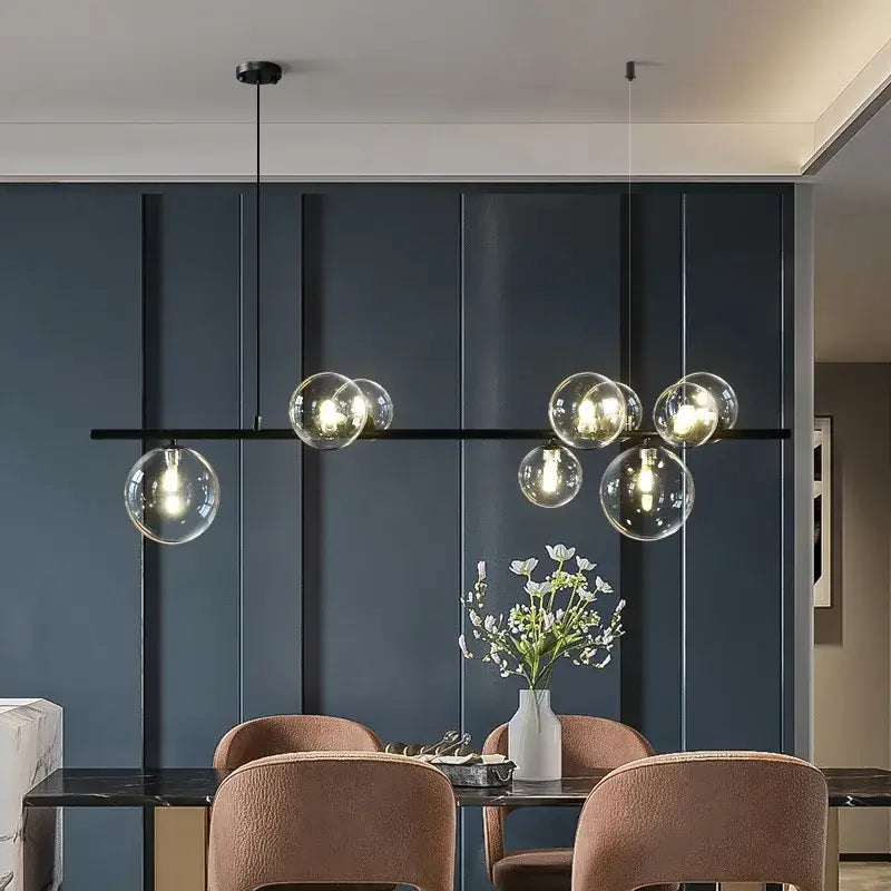 Modern black glass ball pendant light with sleek horizontal bar and warm bulbs for dining room decorbites glass ball pendant