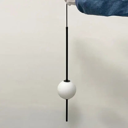 Minimalist white glass ball pendant light with sleek black rod and base ideal for modern dining room decorbites pendant lights