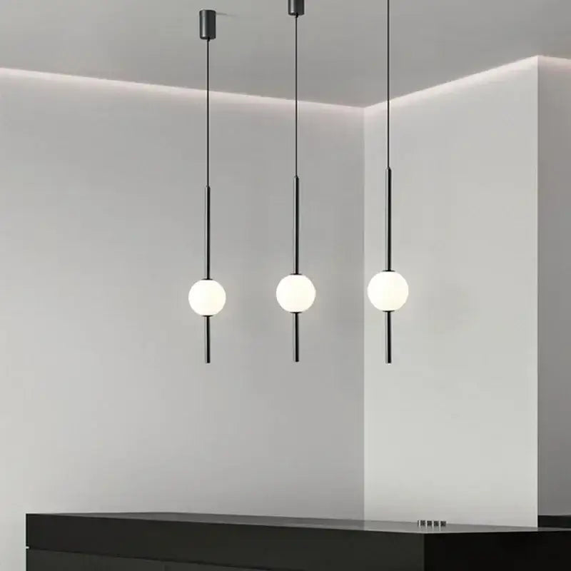 Modern black glass ball pendant lights with frosted white spherical bulbs and black rods for dining room decorbites glass ball pendant