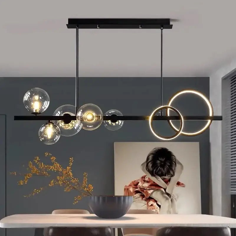 Modern black metal glass bubble chandelier with glowing gold rings and clear globe bulbs for dining room decorbites glass bubble