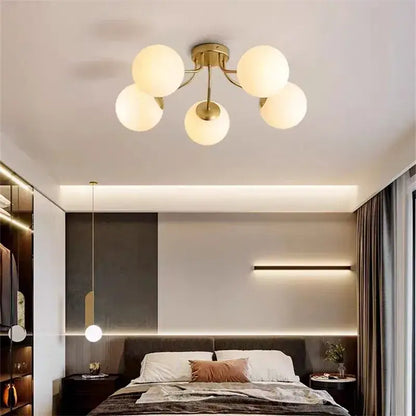 Modern black decorbites glass bubble led ceiling light with five gold-toned frosted glass globe shades for living room decor