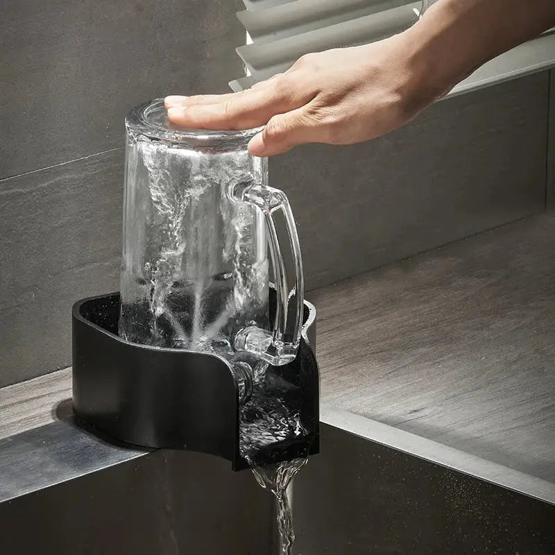 Modern black glass cup washer rinser with a clear glass pitcher in a black plastic sink drain catcher by decorbites glass