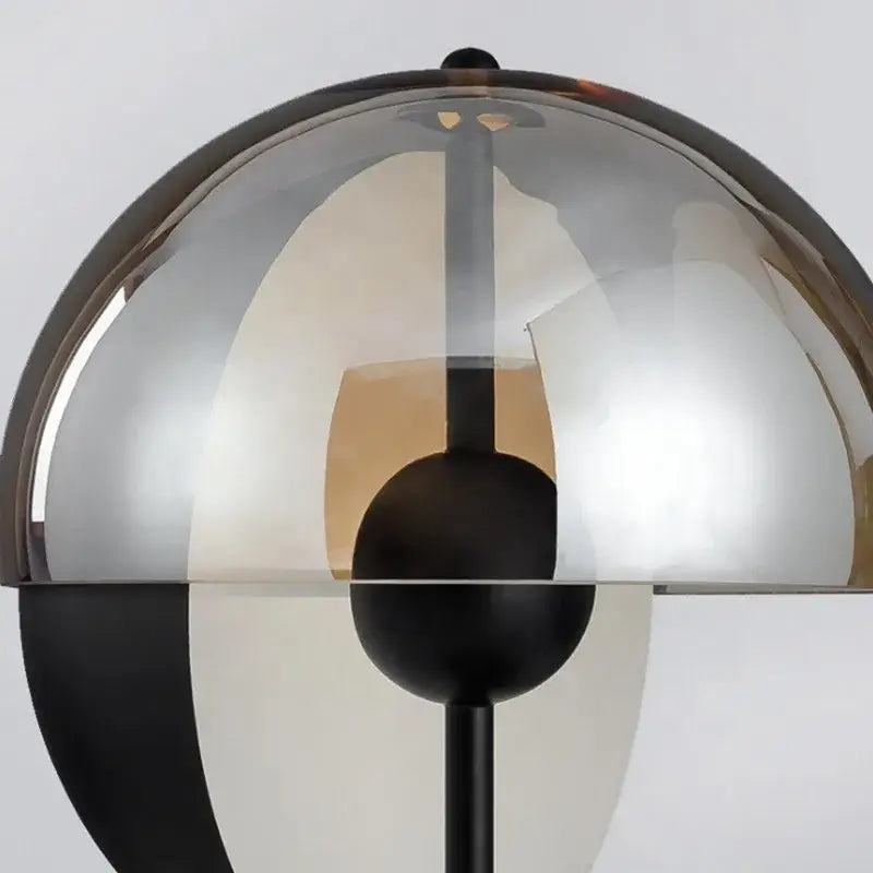 A modern black glass designer bedside lamp with a translucent smoked dome and black metal base for bedroom decorbites