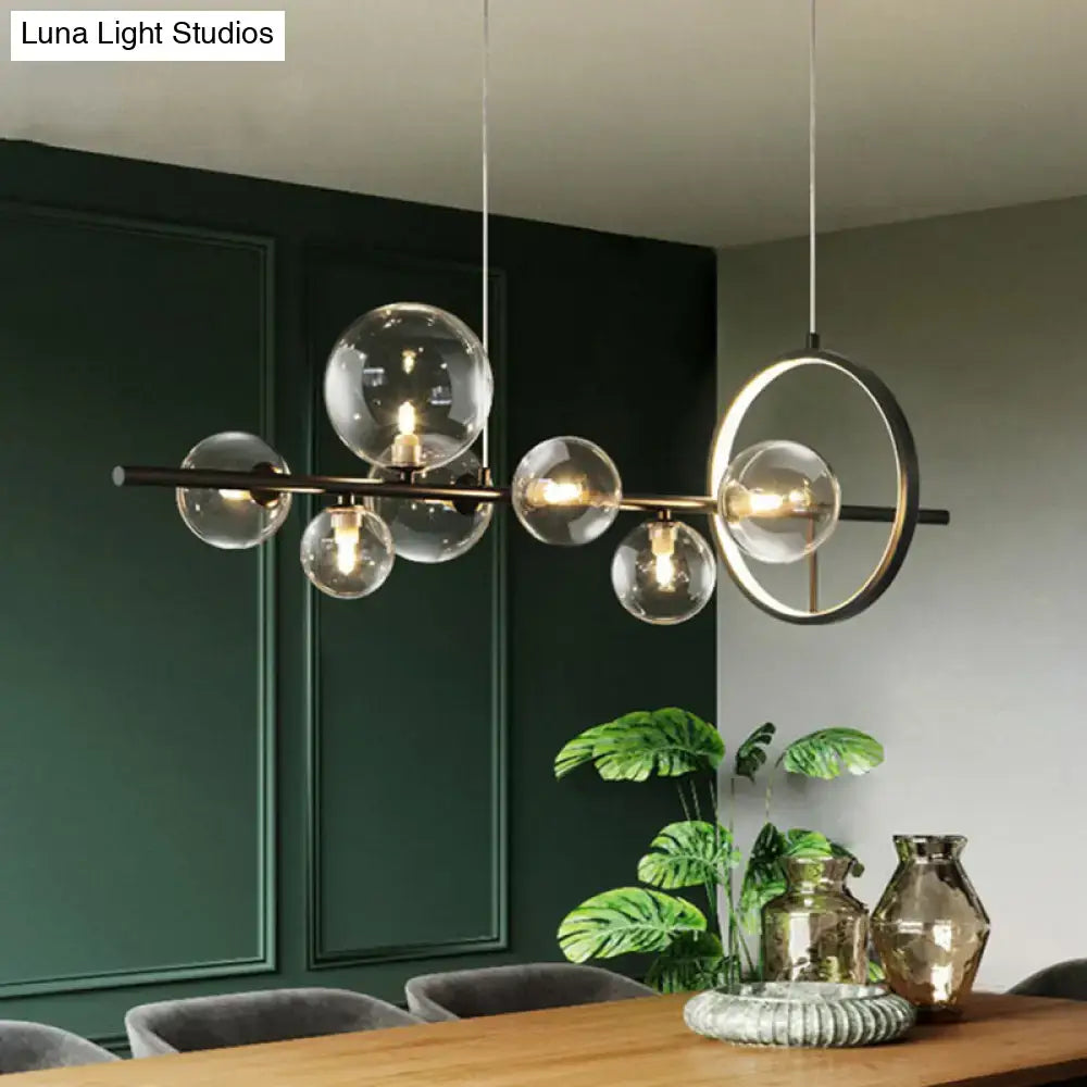 Modern black glass globe pendant light with sleek brass frame and circular accent designed for dining table bulb base