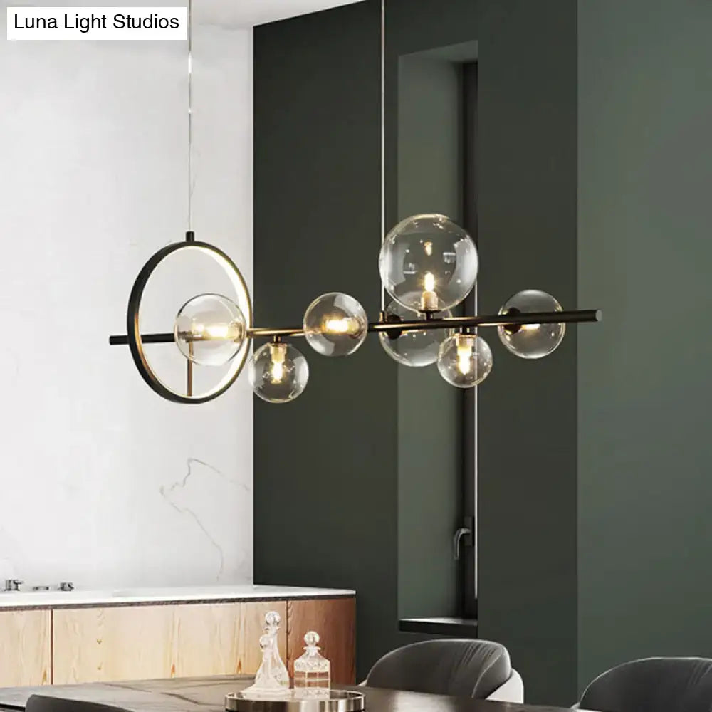 Modern black glass globe pendant light with clear glass bulbs and circular accent ring for dining table lighting