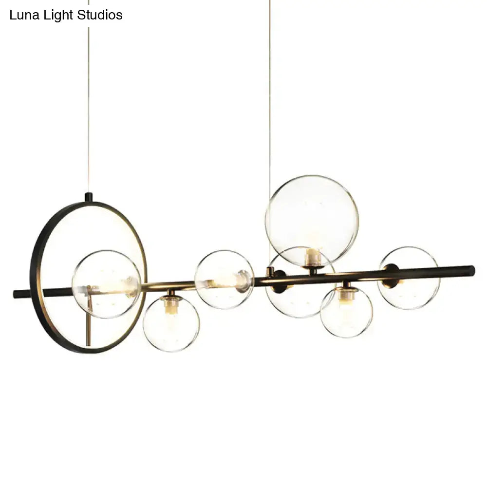 Modern black glass globe pendant light with clear glass spherical bulbs and circular accent for dining table lighting