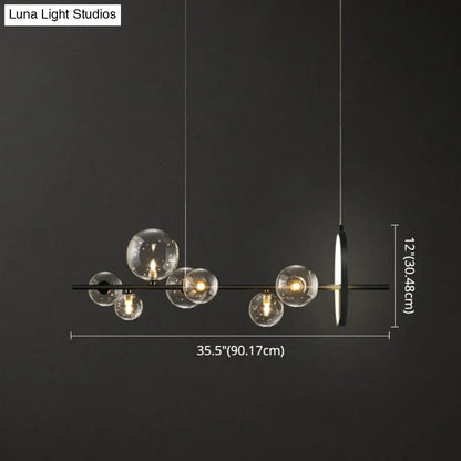 Modern black glass globe pendant light with clear glass bulb base and sleek metal design for dining table lighting