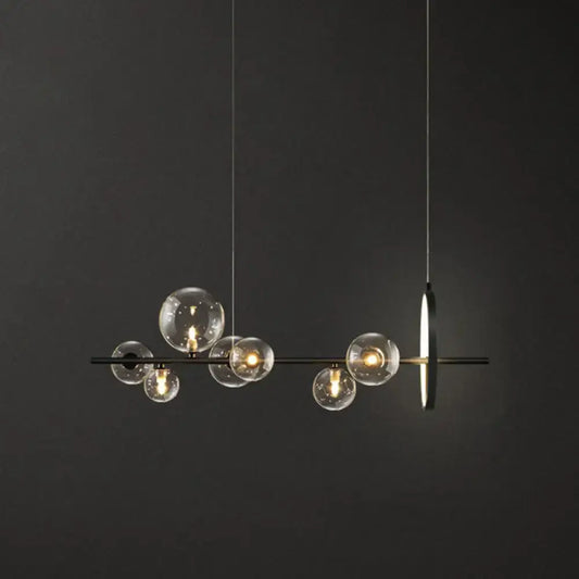 Modern black glass globe pendant light with clear bulb base and minimalist metal design for dining table illumination