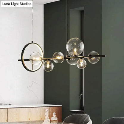 Modern black metal chandelier with clear glass globe bulbs and circular accent ring for dining table light type