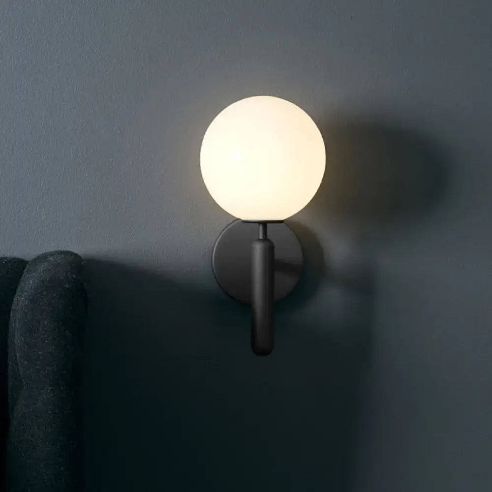 A sleek matte black wall lamp with a frosted glass globe light fixture for 220v-240v and 110v-120v use