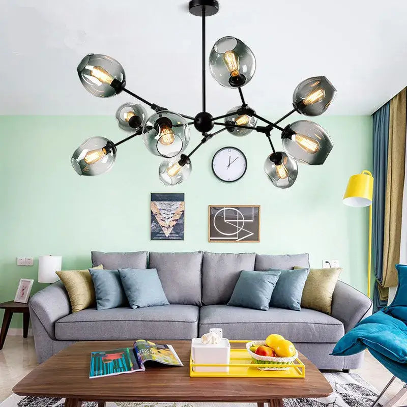 Modern black metal led chandelier with frosted glass globe shades and exposed filament bulbs for dining room lighting